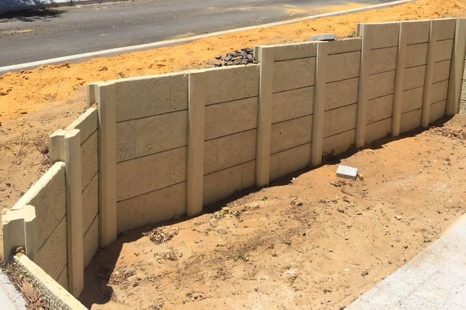 Concrete retaining wall built on a sloping Canberra property