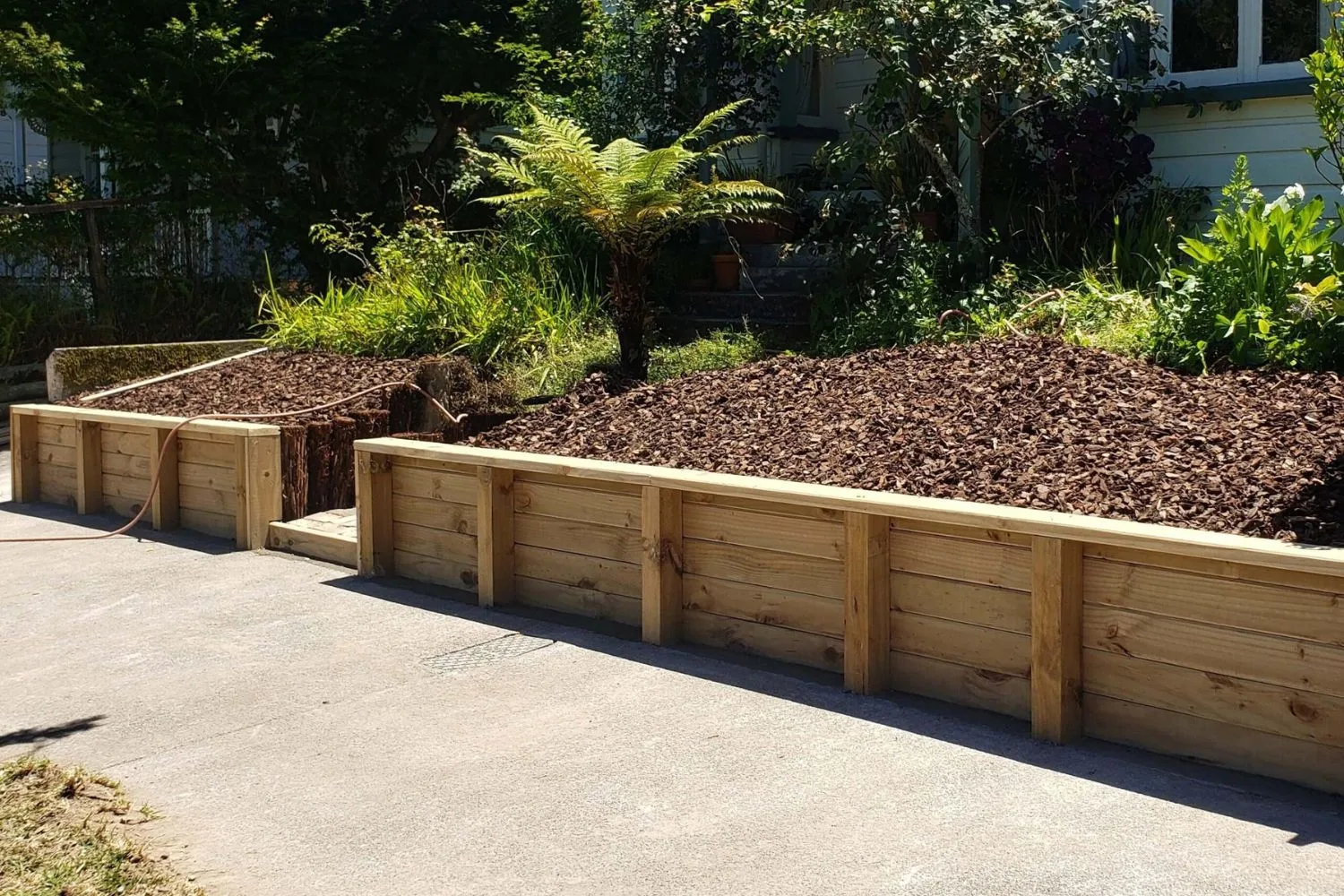 Curved timber retaining wall finished for a Canberra property